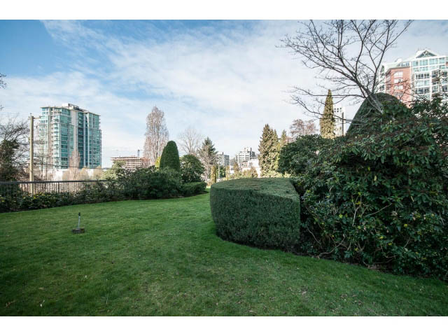 Furnished living room with city view and lush greenery. - 1604 - 145 St Georges Ave, North Vancouver