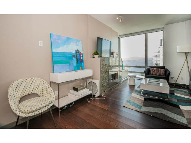 Furnished living room with hardwood floors, city view, and modern decor. - 2404 - 1500 Hornby St, Vancouver Downtown