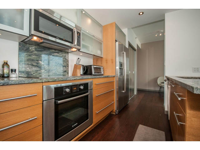 Bright kitchen with modern appliances, granite countertops, and hardwood floors. - 2404 - 1500 Hornby St, Vancouver Downtown
