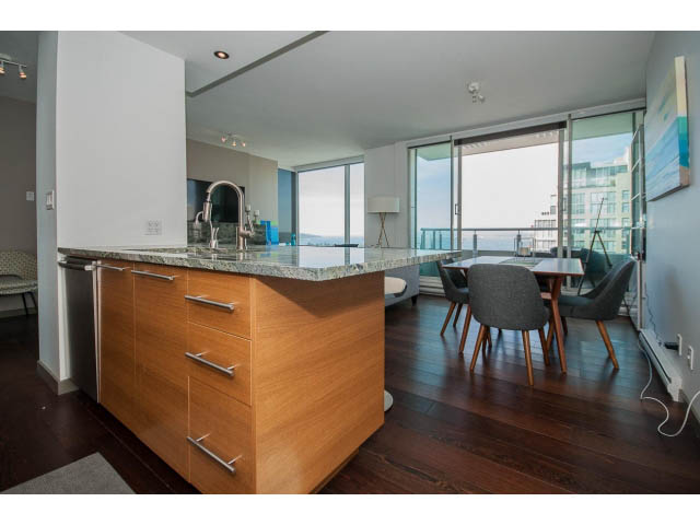 Bright kitchen with granite countertops, hardwood floors, and a city view. - 2404 - 1500 Hornby St, Vancouver Downtown