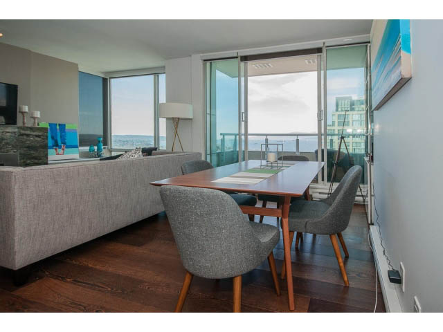 Furnished living room with hardwood floors, city view, and modern decor. - 2404 - 1500 Hornby St, Vancouver Downtown