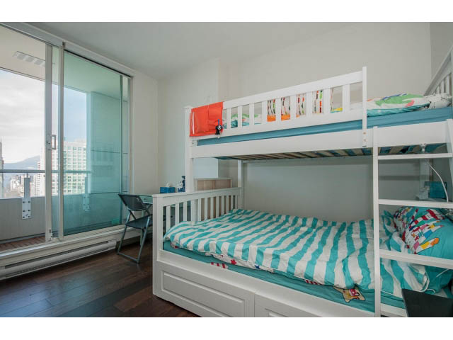 Bright bedroom with bunk beds, hardwood floors, and a city view. - 2404 - 1500 Hornby St, Vancouver Downtown