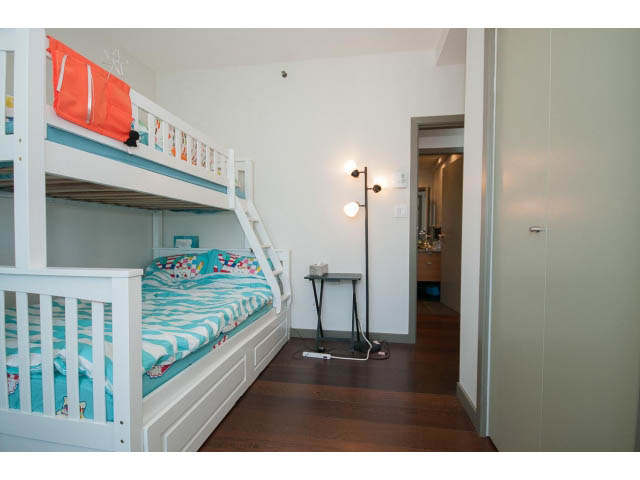 Bright bedroom with bunk beds, hardwood floors, and a city view. - 2404 - 1500 Hornby St, Vancouver Downtown