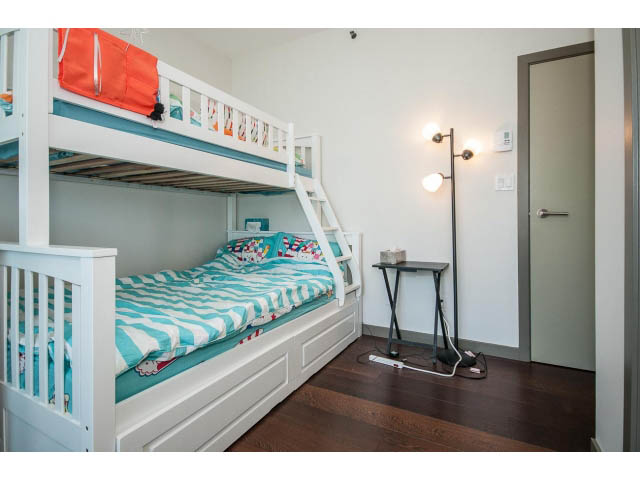 Bright bedroom with bunk beds, hardwood floors, and a city view. - 2404 - 1500 Hornby St, Vancouver Downtown