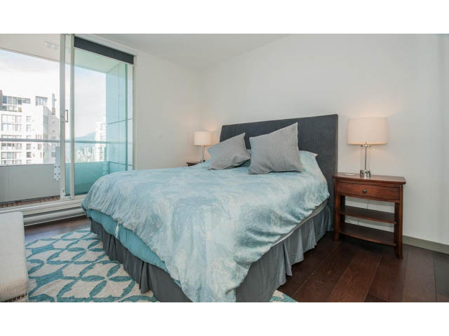 Spacious bedroom with hardwood floors, city view, and modern furnishings. - 2404 - 1500 Hornby St, Vancouver Downtown