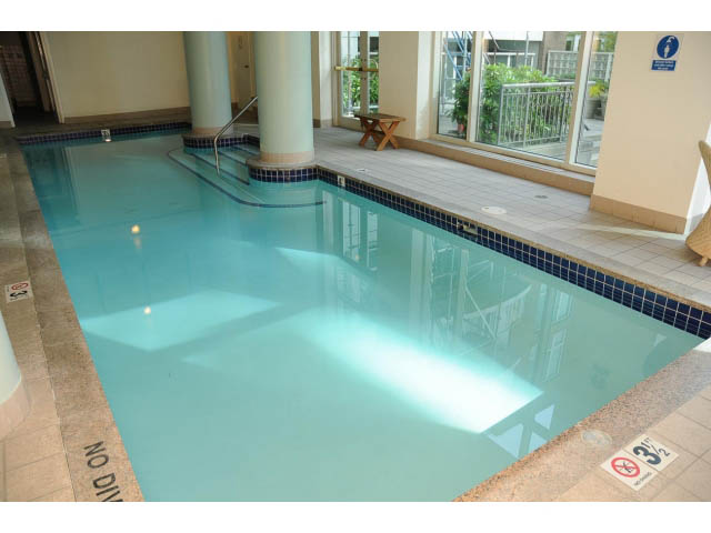 Spacious living room with large windows and a cozy fireplace. - 2404 - 1500 Hornby St, Vancouver Downtown