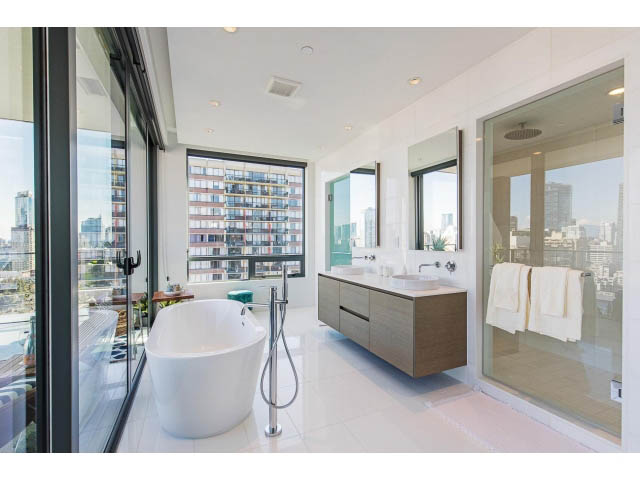 Spacious bathroom with city view, modern fixtures, and large windows. - 1901 - 1171 Jervis St, Vancouver Downtown