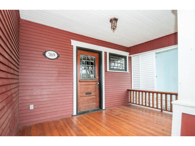 Furnished entryway with wooden floors and red siding. - 769 West 20th Ave, Vancouver West Side