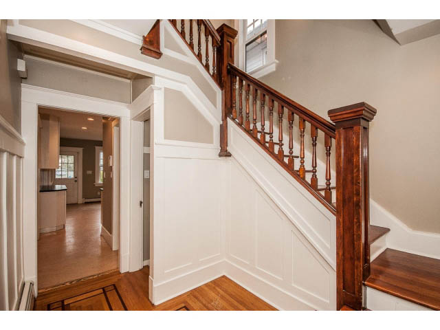 Staircase with wooden railings and white paneling leading to upper level. - 769 West 20th Ave, Vancouver West Side