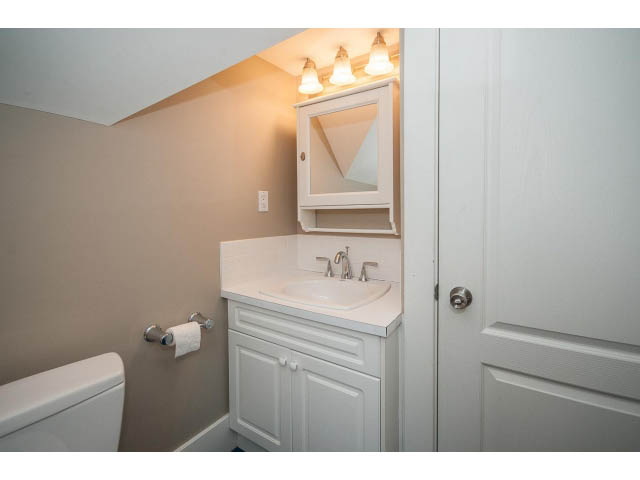 Bathroom with white cabinets and a sink, light fixture above. - 769 West 20th Ave, Vancouver West Side