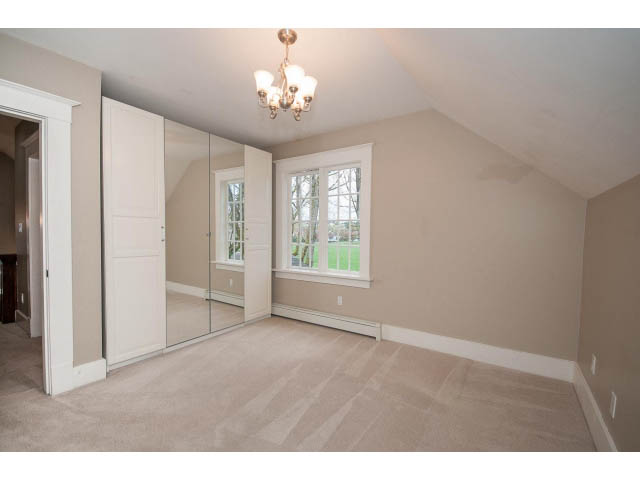 Spacious bedroom with large mirrored closet and natural light from windows. - 769 West 20th Ave, Vancouver West Side