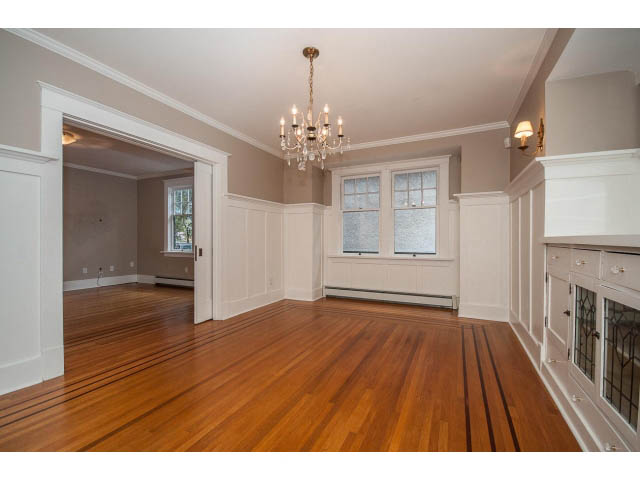 Bright living room with hardwood floors and a chandelier, showcasing a spacious and elegant interior. - 769 West 20th Ave, Vancouver West Side