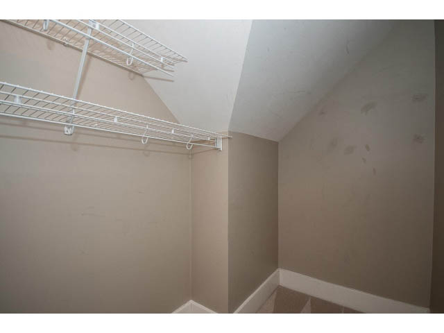 Attic storage area with metal shelving and sloped ceiling. - 769 West 20th Ave, Vancouver West Side