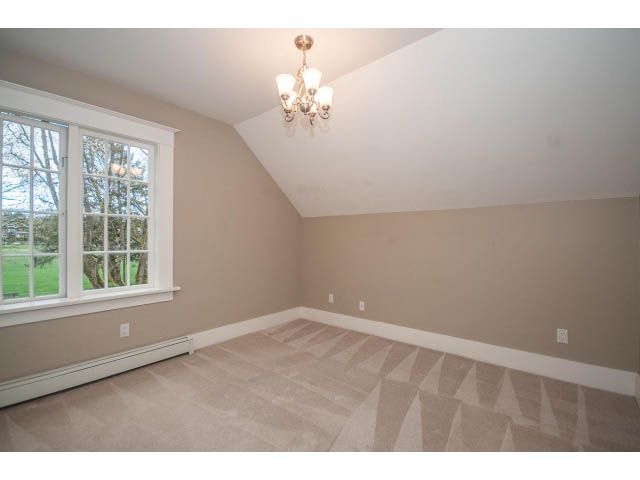 Bright living room with carpeted floor and large window view. - 769 West 20th Ave, Vancouver West Side