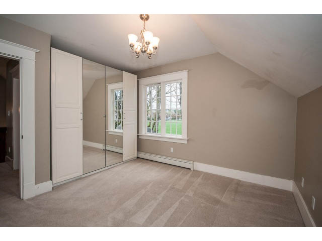 Spacious attic bedroom with large windows and carpeted floors. - 769 West 20th Ave, Vancouver West Side