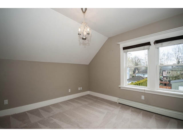 Bright living room with herringbone carpet and city view. - 769 West 20th Ave, Vancouver West Side