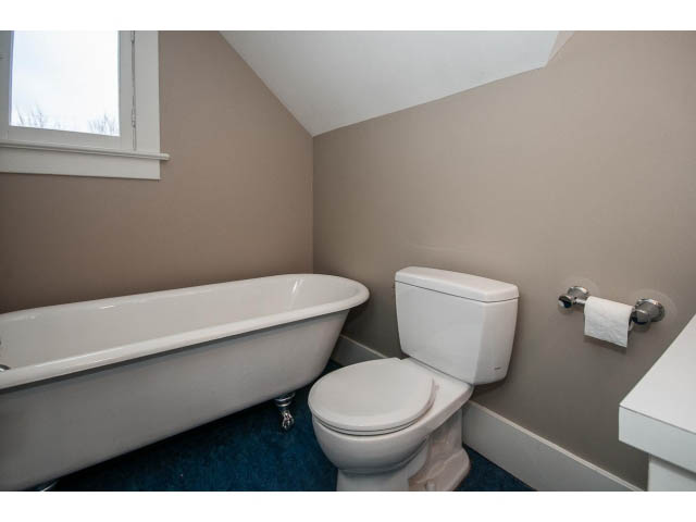 Bright bathroom with white fixtures and beige walls. - 769 West 20th Ave, Vancouver West Side