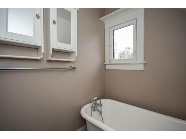 Bright bathroom with white clawfoot tub and built-in cabinets. - 769 West 20th Ave, Vancouver West Side