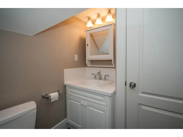Furnished bathroom with white cabinets and a sink, modern lighting above. - 769 West 20th Ave, Vancouver West Side