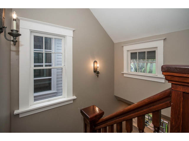 Staircase with wooden banister and windows with shutters. - 769 West 20th Ave, Vancouver West Side