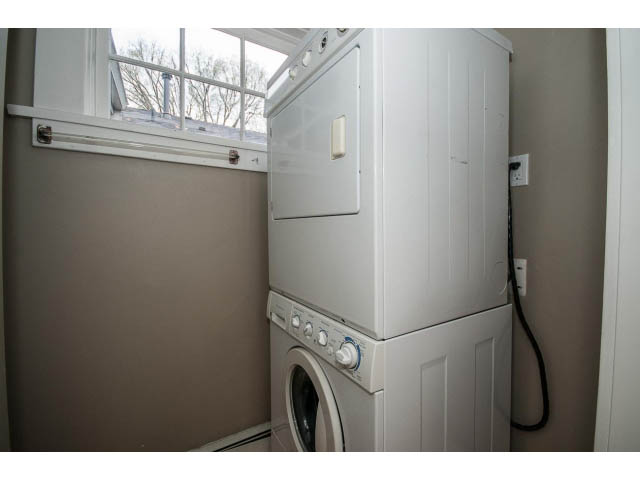 Laundry room with stacked washer and dryer, window above. - 769 West 20th Ave, Vancouver West Side