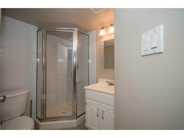 Bright bathroom with white cabinets and glass shower, modern design. - 769 West 20th Ave, Vancouver West Side