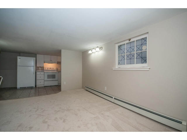 Bright kitchen with white appliances and tiled floors. - 769 West 20th Ave, Vancouver West Side