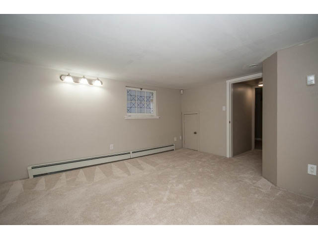 Spacious living room with carpeted floors and recessed lighting. - 769 West 20th Ave, Vancouver West Side