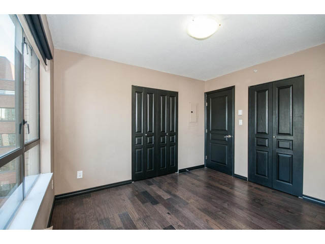 Bright living room with hardwood floors and black doors. - 1808 - 1189 Howe St, Vancouver Downtown