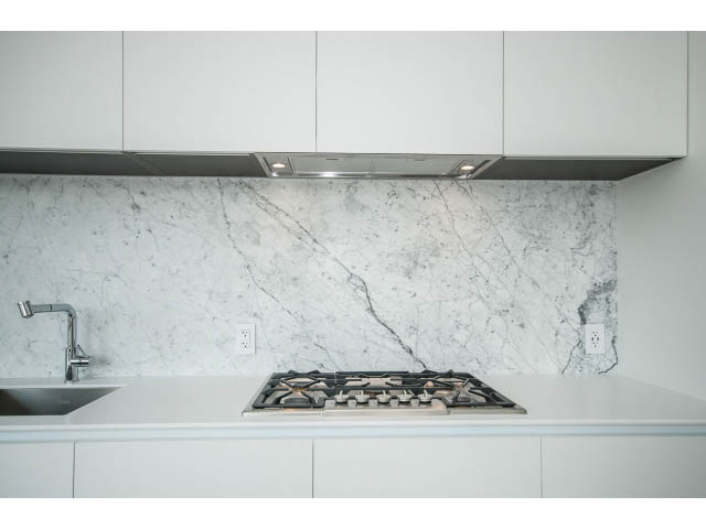 Bright kitchen with white marble backsplash and modern gas stove, clean and modern design. - 804 - 1171 Jervis St, Vancouver Downtown