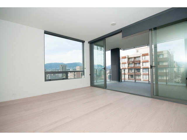 Spacious living room with large windows, hardwood floors, and city views. - 804 - 1171 Jervis St, Vancouver Downtown