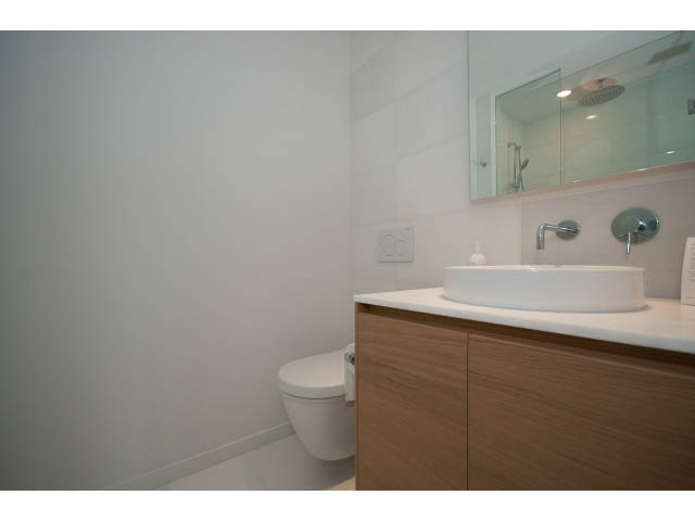 Bright bathroom with wooden vanity and modern fixtures. - 804 - 1171 Jervis St, Vancouver Downtown