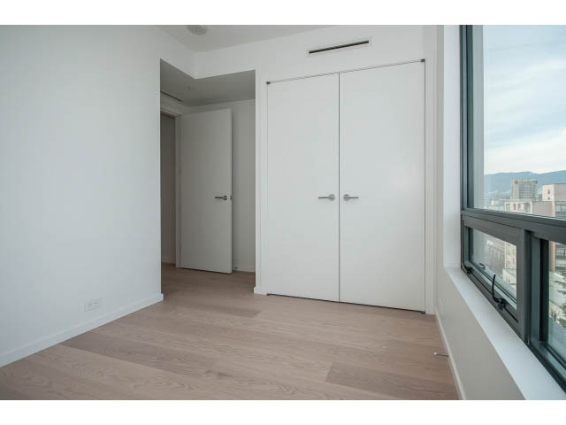 Bright living room with hardwood floors and city view. - 804 - 1171 Jervis St, Vancouver Downtown