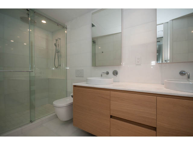 Bright bathroom with wooden vanity and glass shower, modern design. - 804 - 1171 Jervis St, Vancouver Downtown