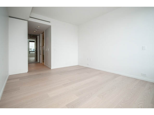 Spacious living room with hardwood floors and a large open space. - 804 - 1171 Jervis St, Vancouver Downtown