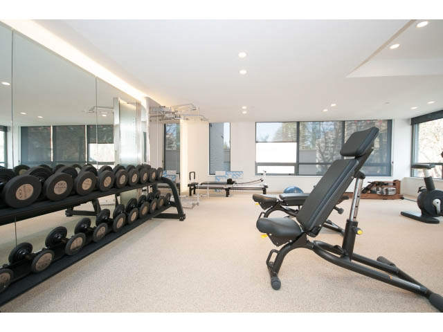 Bright gym with exercise equipment and large windows. - 804 - 1171 Jervis St, Vancouver Downtown