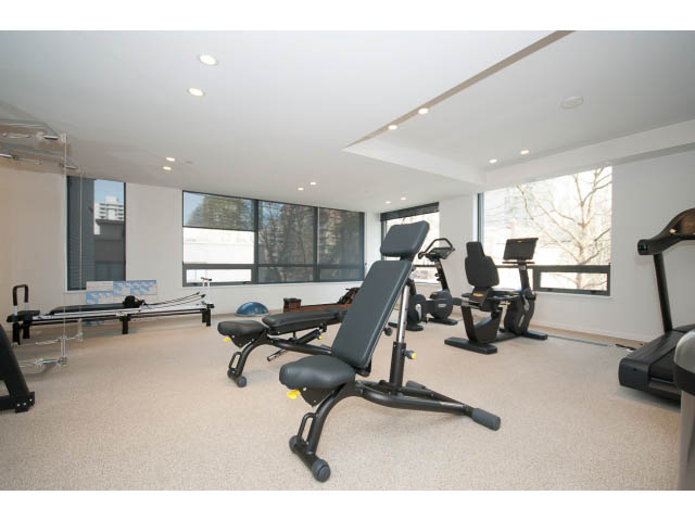 Bright exercise room with large windows, city view, and modern equipment. - 804 - 1171 Jervis St, Vancouver Downtown