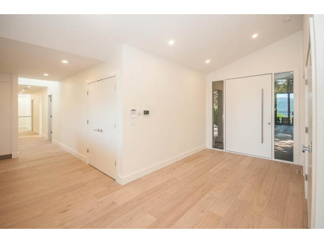 Bright open-concept living area with hardwood floors and a modern design. - 5235 Headland Dr., West Vancouver