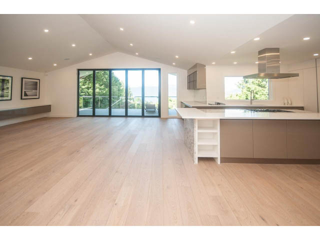 Bright kitchen with modern island, hardwood floors, and city view. - 5235 Headland Dr., West Vancouver