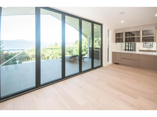 Bright living room with hardwood floors and city view. - 5235 Headland Dr., West Vancouver