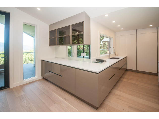 Bright kitchen with modern cabinets, hardwood floors, and a city view. - 5235 Headland Dr., West Vancouver