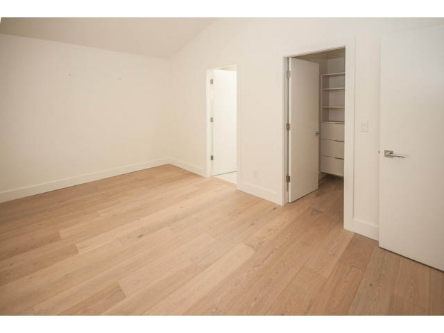 Bright living room with hardwood floors and white walls. - 5235 Headland Dr., West Vancouver