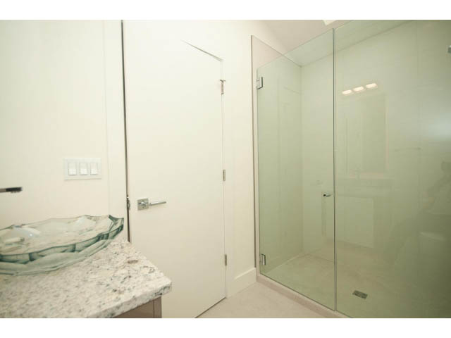 Bright bathroom with granite countertop and glass shower door. - 5235 Headland Dr., West Vancouver