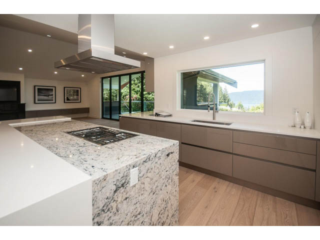 Bright kitchen with granite countertops, hardwood floors, and a city view. - 5235 Headland Dr., West Vancouver
