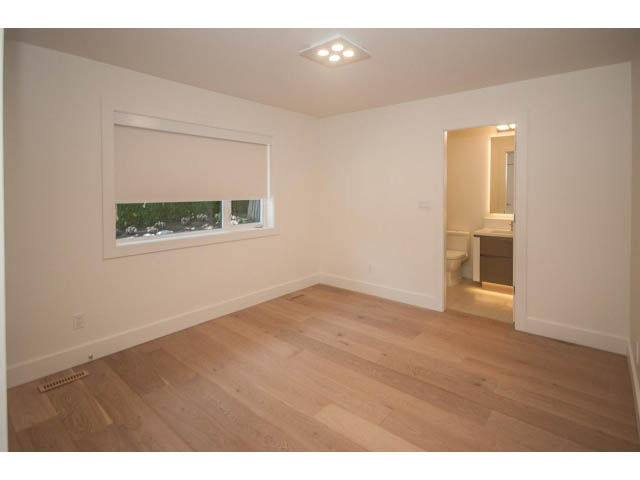 Bright living room with hardwood floors and a city view. - 5235 Headland Dr., West Vancouver