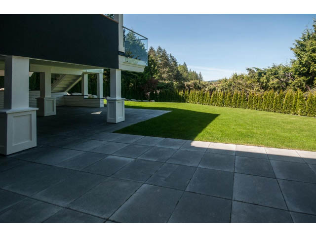 Furnished patio with modern paving and lush green lawn. - 5235 Headland Dr., West Vancouver