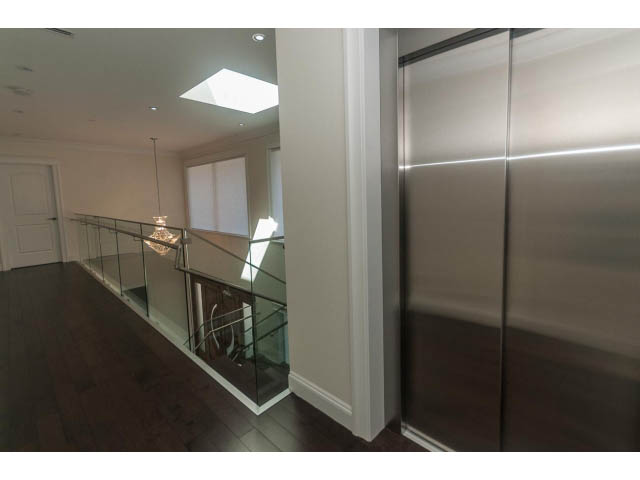 Staircase with glass railings and hardwood floors. - 2333 Mathers Ave, West Vancouver