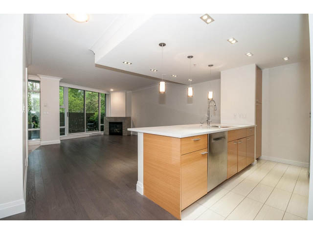Bright kitchen with white countertops, hardwood floors, and a city view. - 21 Smithe Mews, Vancouver Downtown