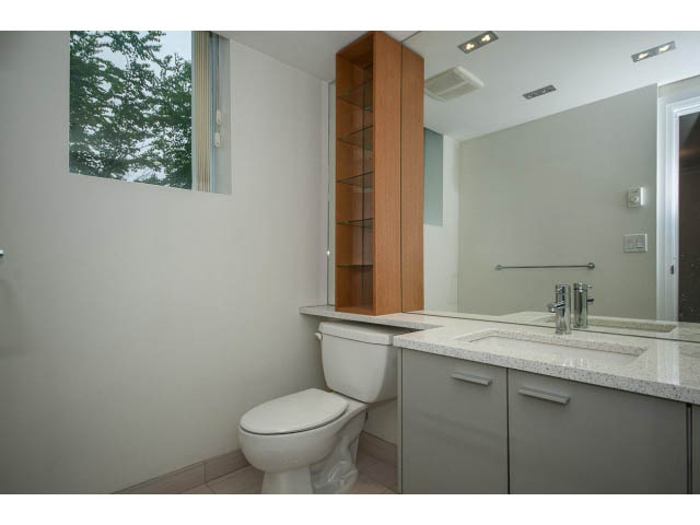 Modern bathroom with sleek countertop and large mirror. - 21 Smithe Mews, Vancouver Downtown