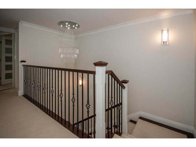 Staircase with elegant chandelier and modern wall sconces. - 21 Smithe Mews, Vancouver Downtown